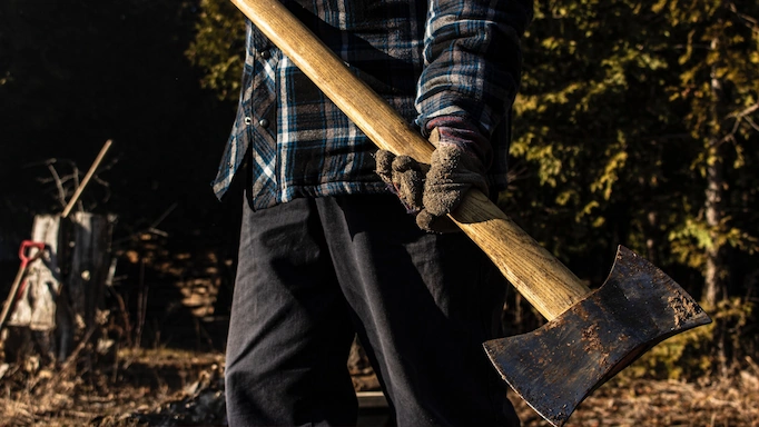 A double-bitted axe is being used