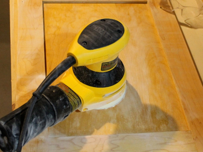 A sander used for sanding cabinet surface