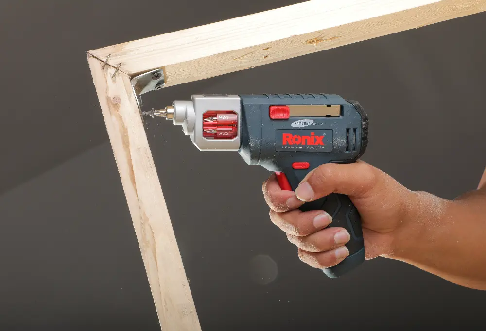  Ronix Drill driver being used to fasten screws into a frame