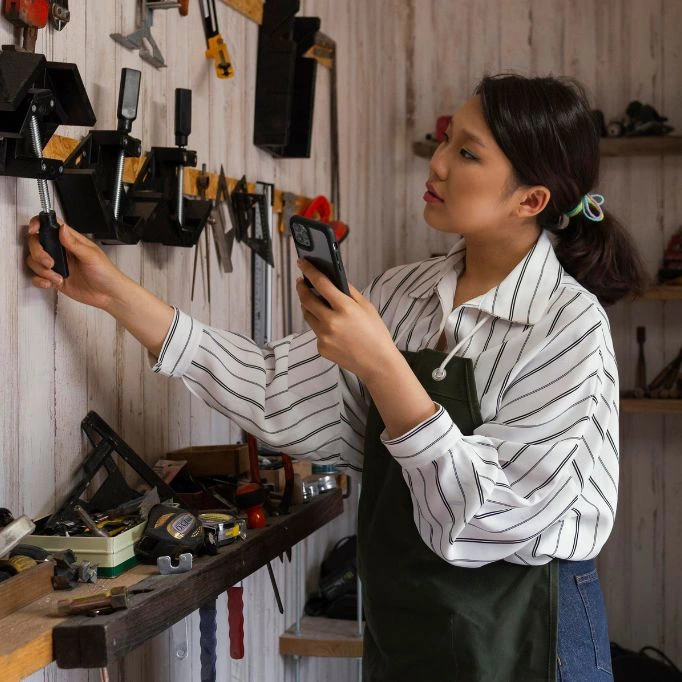 picture of a girl using a hardware shop CRM software on their phone 