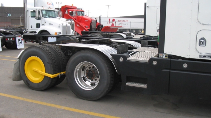 A Trailer with a wheel clamp on its wheels