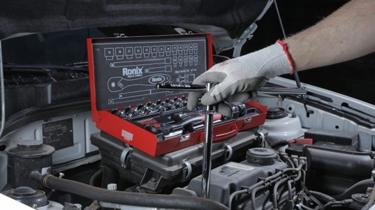 A picture of socket set being used on a car