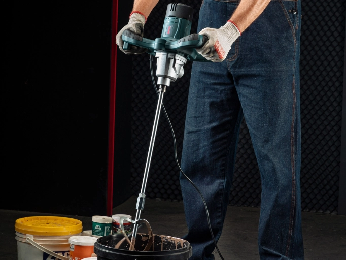 a man mixing the material with Ronix Paddle Mixer