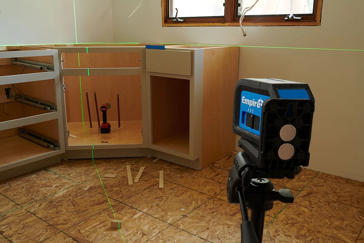 Using a green beam laser level for fast and accurate alignment in cabinet installation