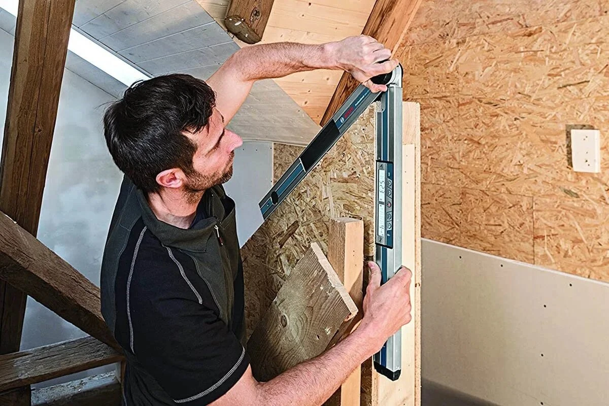 Man using an angle finder to measure angles on a wooden workpiece