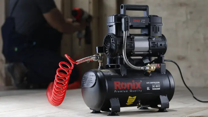 A man using a Ronix air compressor to power up an air tool