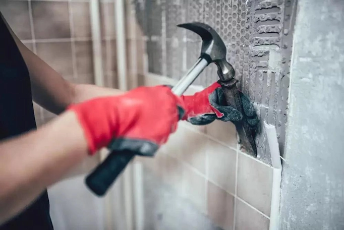 Hammer and chisel is used to remove tiles