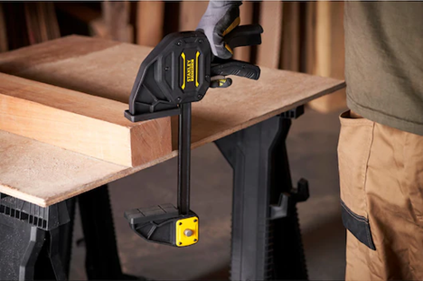 picture of a man using a Stanley clamp for woodworking 