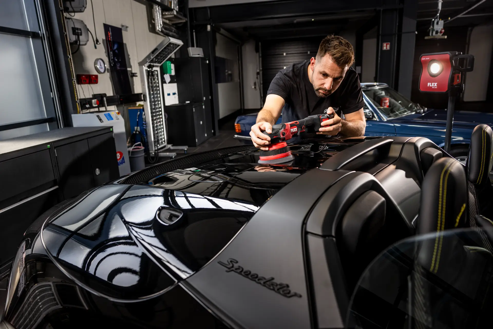 A detailer is using Flex XFE 15 cordless car buffer on a car