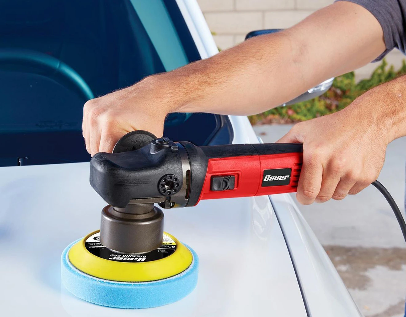 Harbor Freight BAUER Dual Action Polisher in the hands of an operator