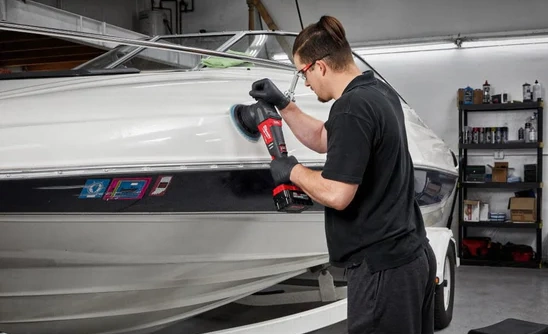 hands of a detailer, polishing a boat with the Milwaukee 2685-20 M18 Random Orbital Polisher