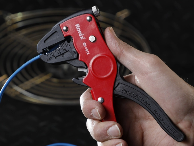 an electrician using a wire stripper
