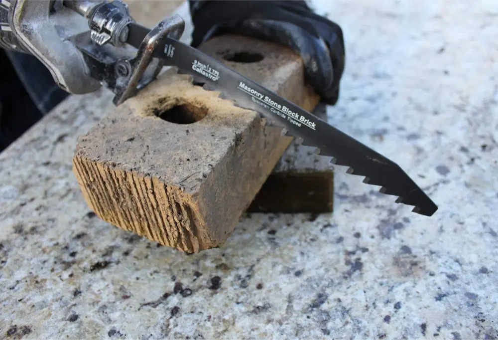 Reciprocating saw cutting a brick