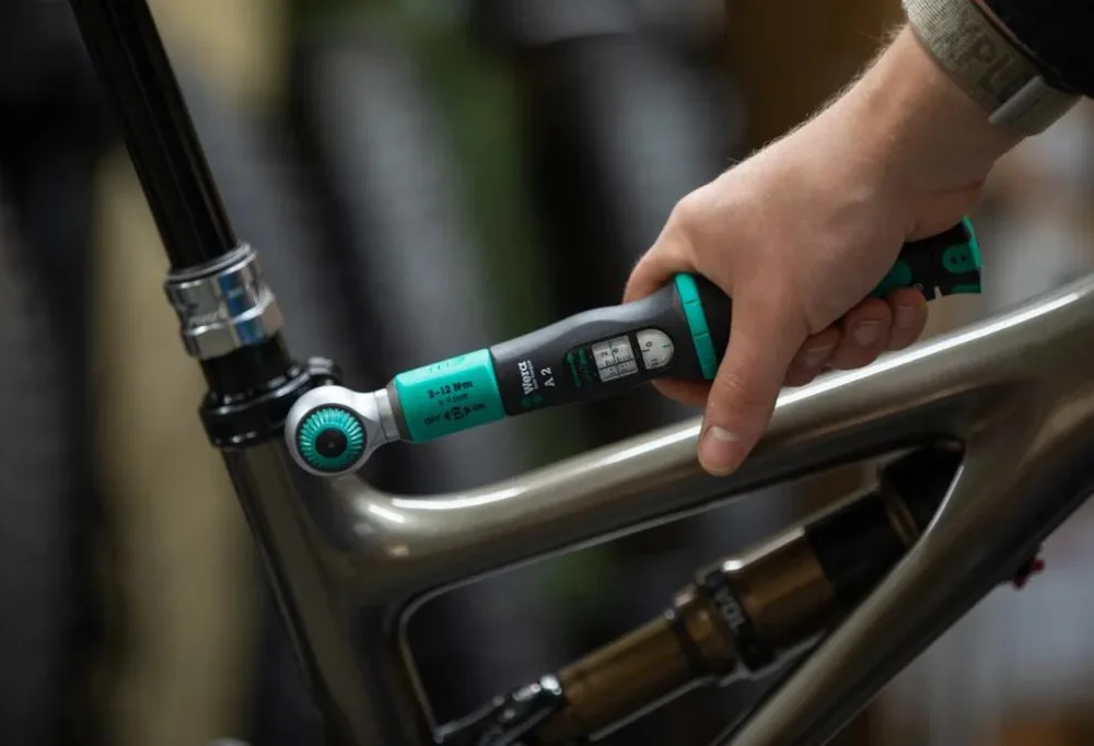 Torque wrench being used on a bike