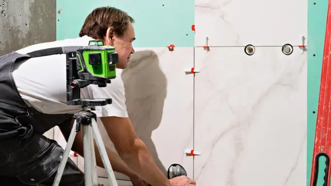 A man using a laser level