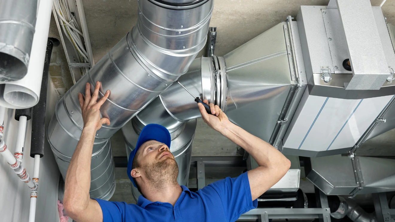 A man checking AC ducts