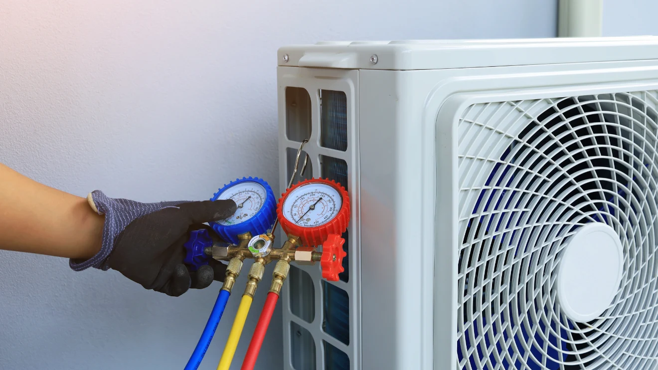 AC Refrigerant lines being checked with two gauges