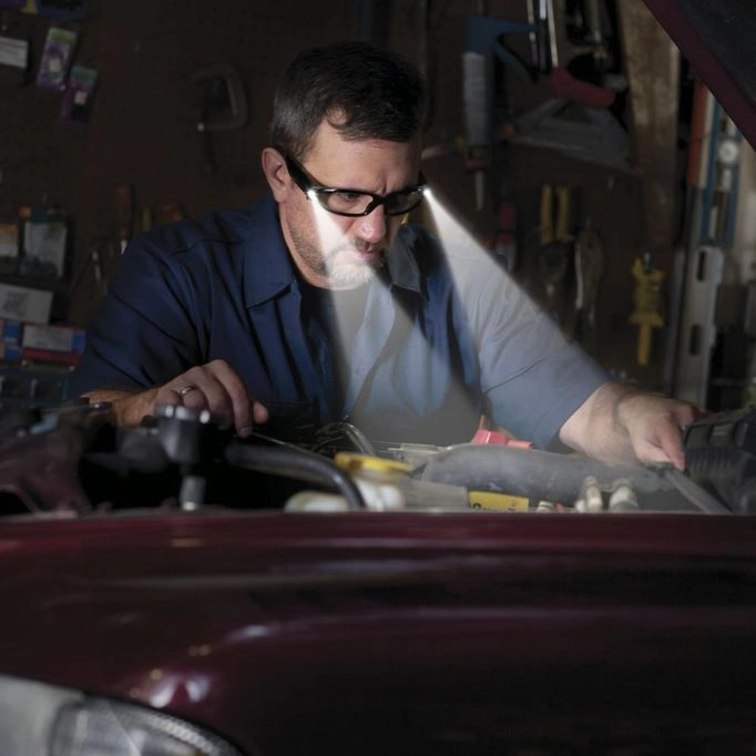 Photo of a mechanic wearing safety glasses while working