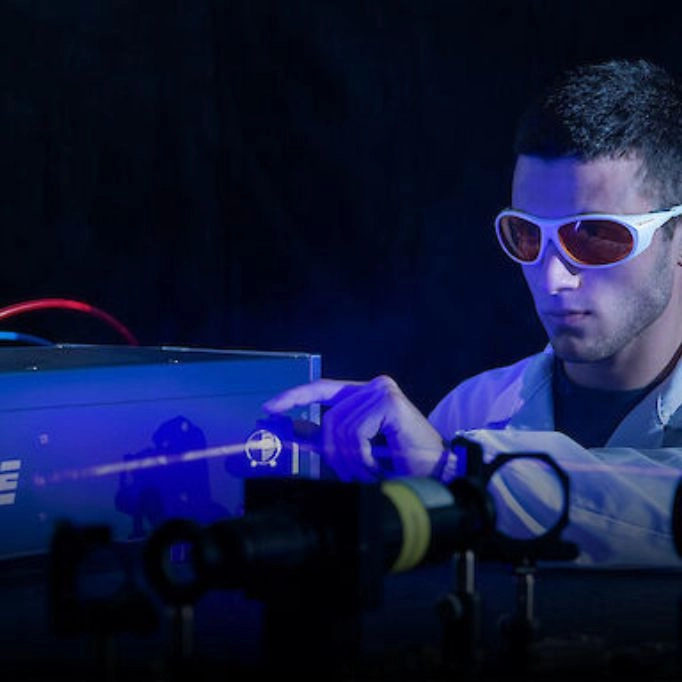 Picture of someone wearing safety glasses while working with lasers