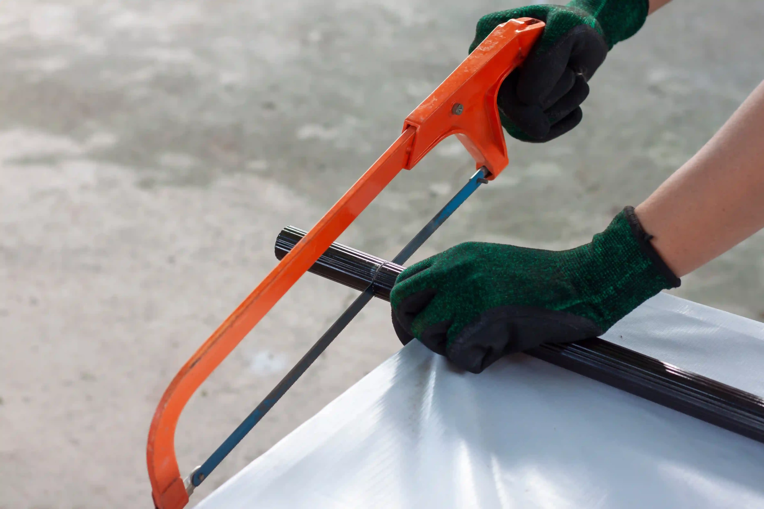 picture of a person working with a hacksaw