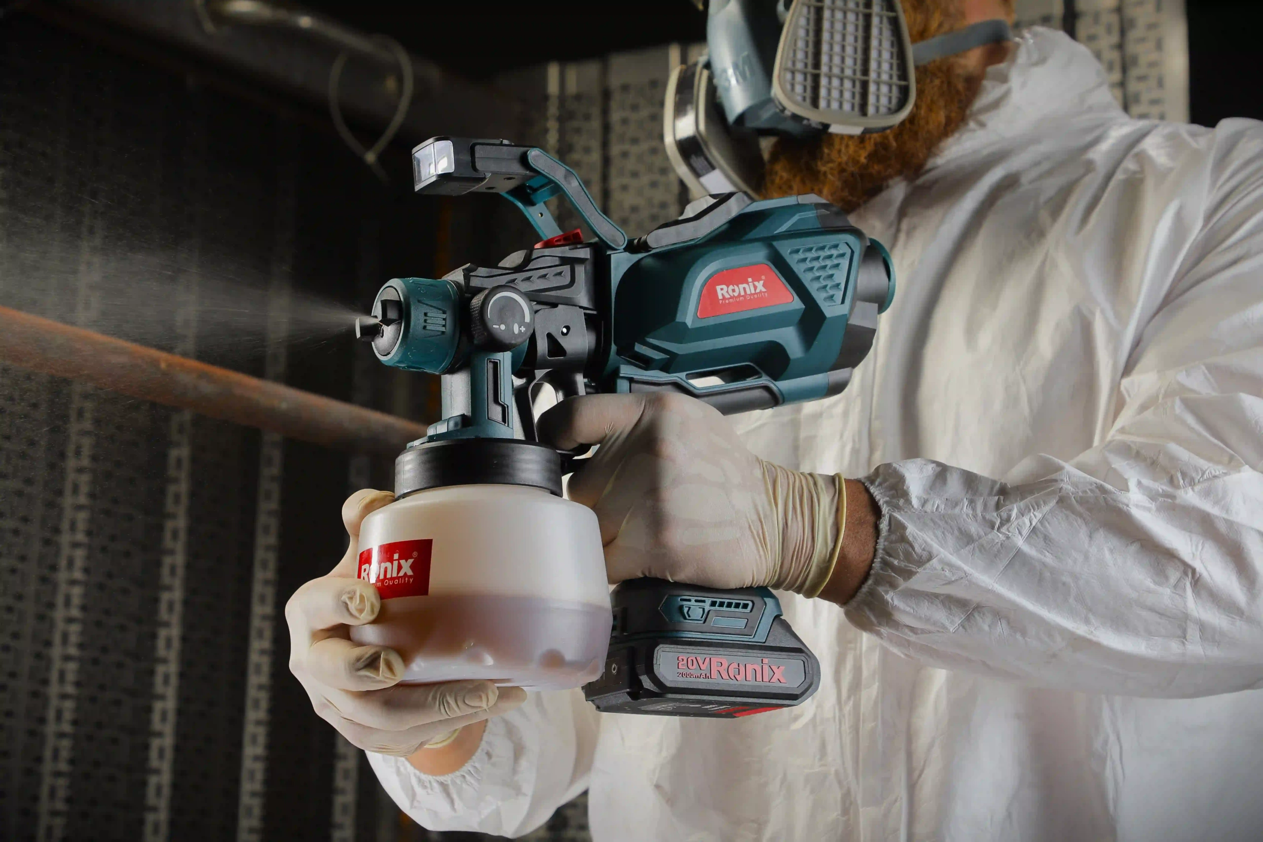 Ronix 8604 20v Cordless Spray Gun 32000RPM being used in a man’s hands.