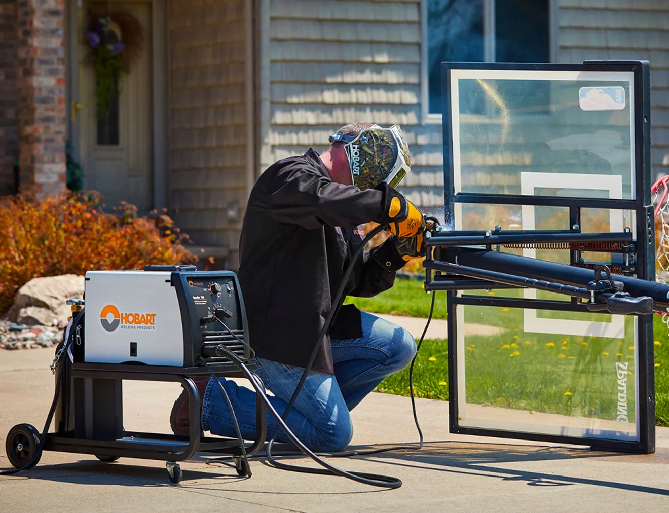 A photo of a man welding with a Hobart MIG welder