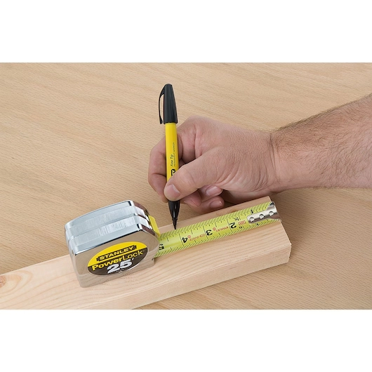 Measuring a wooden piece with the Stanley PowerLock Tape Measure