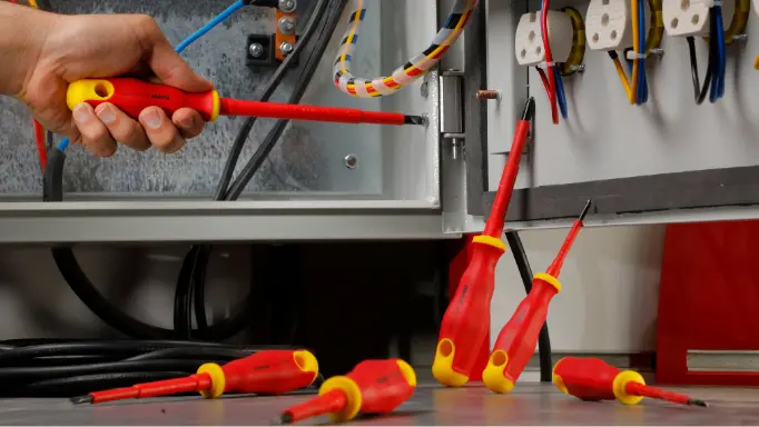 An electrician using Ronix insulated screwdriver set