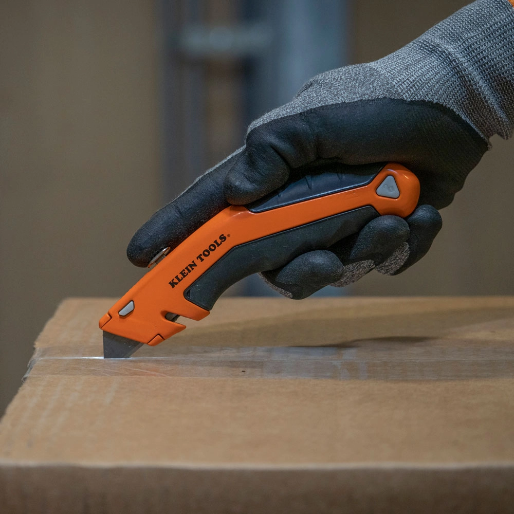 picture of a person using a Klein retractable box cutter 