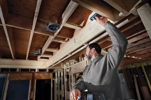 A man working with Bosch GLM 20 in a jobsite