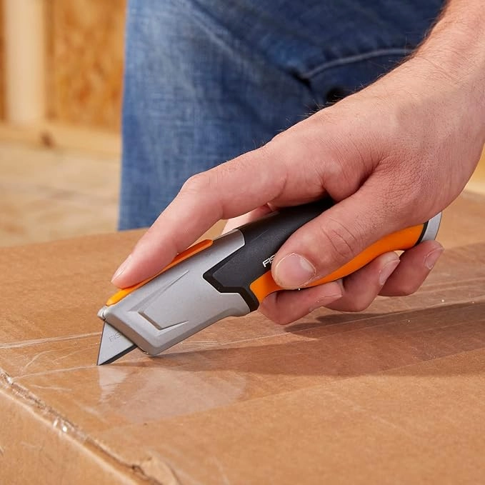 picture of a person using Fiskars box cutter