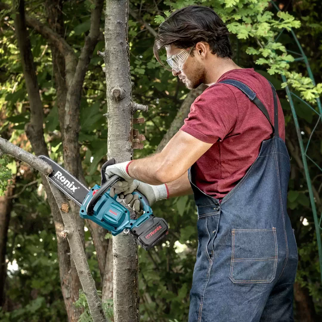 picture of a person using the Ronix battery chainsaw