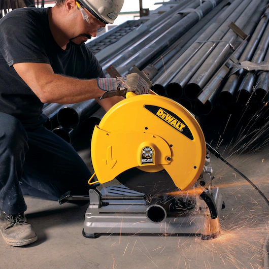 picture of a person using the DeWalt chop saw