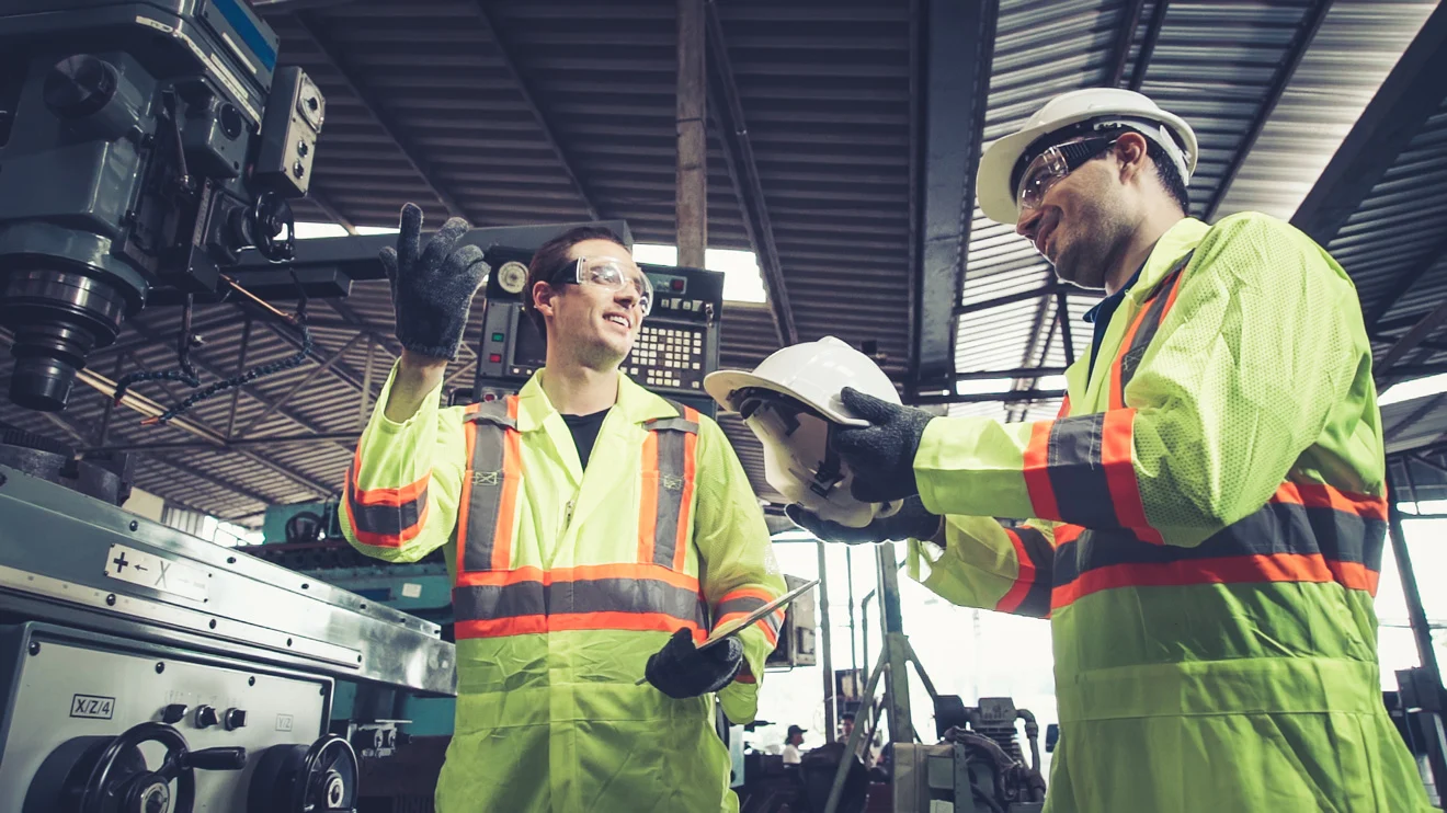 A photo of the two industry workers wearing protective equipment