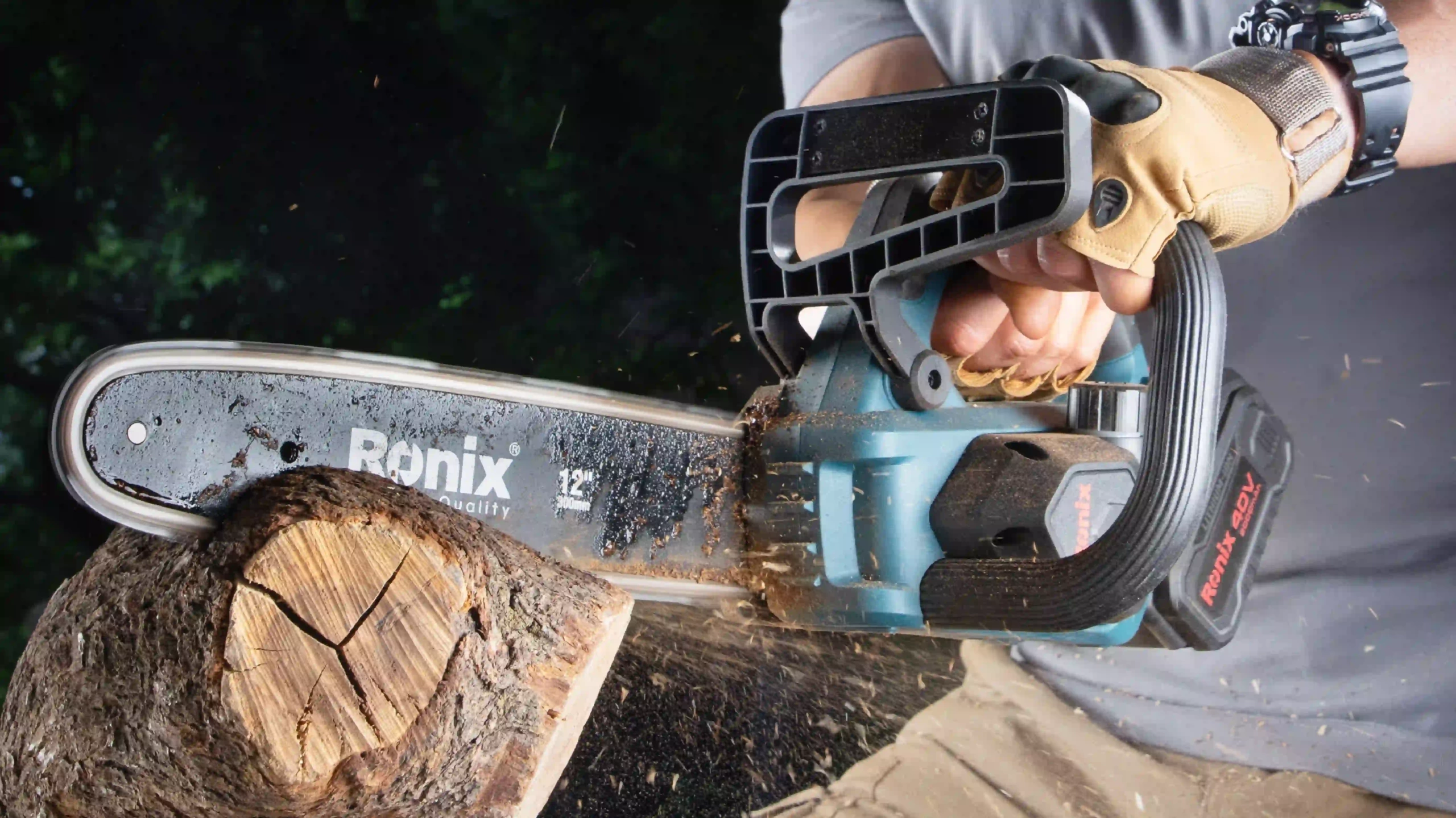 picture of a man using the Ronix 8923 Brushless Chainsaw Kit