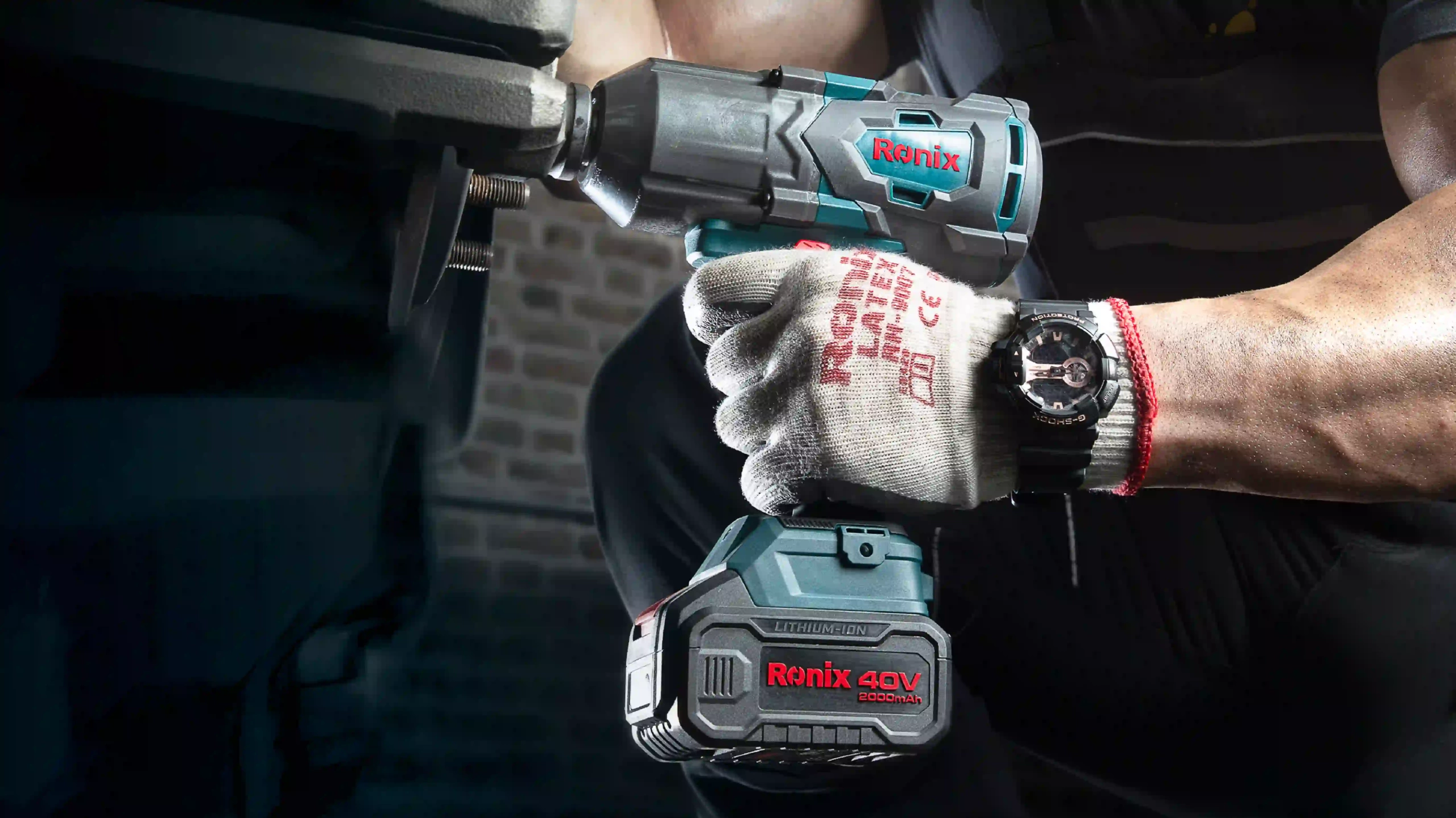 picture of a man using the Ronix 8927 Brushless Cordless Impact Wrench Kit
