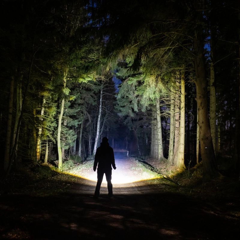A Picture of a Man Using Best Hunting Flashlight