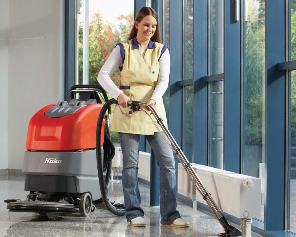 picture of a person using Hako industrial vacuum cleaner