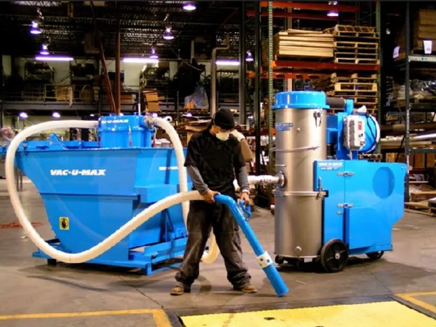 picture of a person using VAC-U-MAX industrial vacuum cleaner.