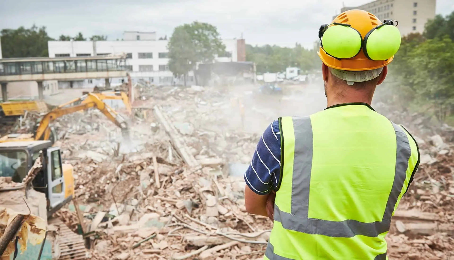 Construction worker with hearing protection at a noisy demolition site
