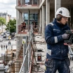 Worker using cordless power tools on an urban construction site