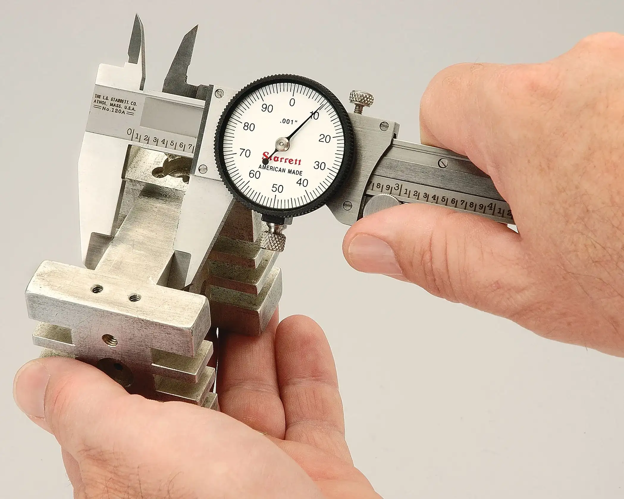Picture of a person using a Starrett caliper